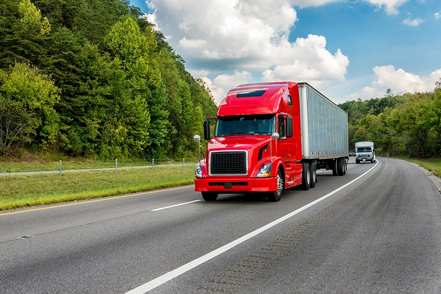 A red semi-trailer driving on the interstate near Decatur, IL, on its way to get trailer maintenance.