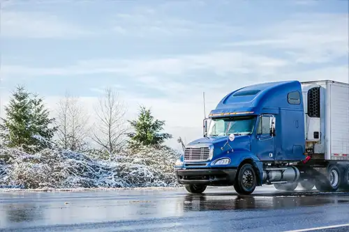 Decatur Trailer Sales & Service - A semi-truck driving along winter roads in Decatur, IL.