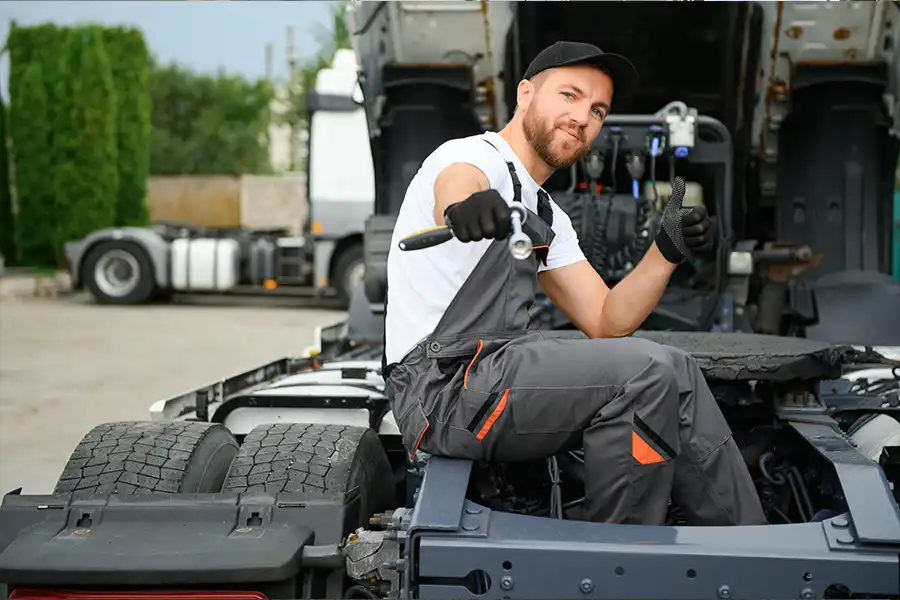 Decatur Trailer Sales & Service—A male mechanic performing maintenance on a semi-truck in Decatur, IL.