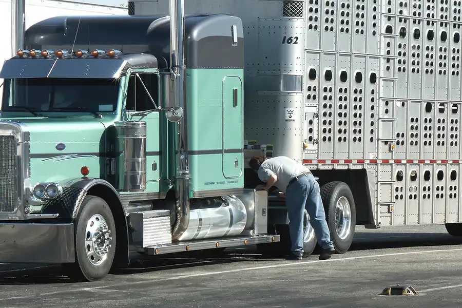 Decatur Trailer Sales & Service—A certified mechanic performs a DOT inspection on a semi-truck to ensure it is safe for travel in Decatur, IL.