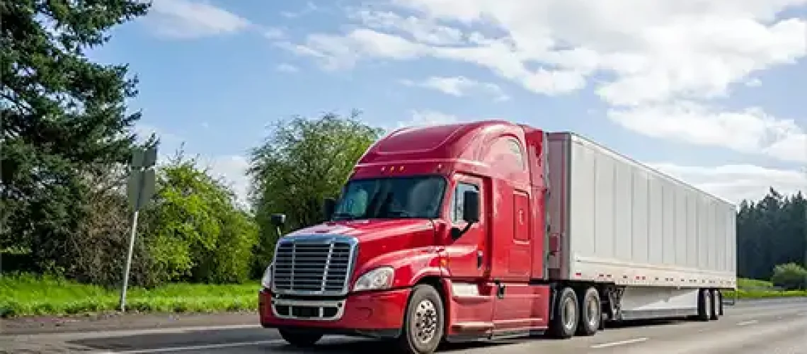 Decatur Trailer Sales & Service - A red commercial trailer travels safely down the road in Decatur, IL