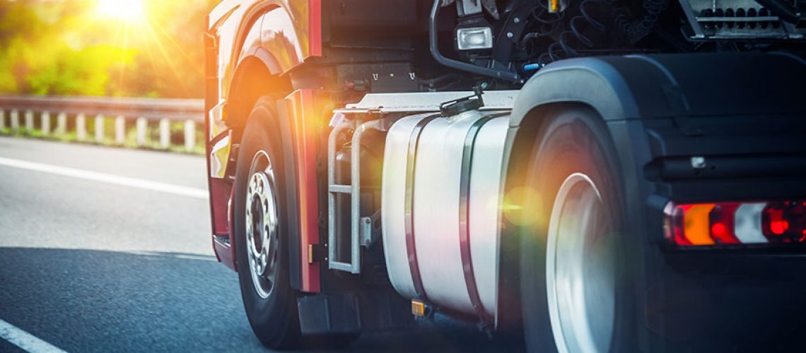 A close-up of a semi-truck's new tires driving on a road in Decatur, IL.